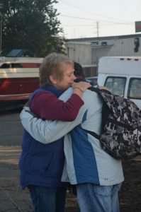 This is a picture of a Hope City Supernatural Training first year student hugging someone during an outreach in Stockton, Ca.
