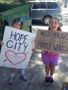 Picture of two girls holding signs.